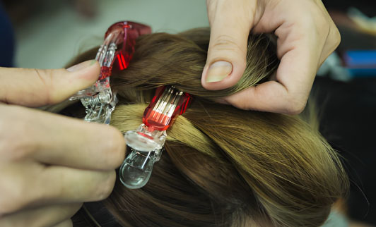 کلیپس سگکی حرفه‌ای در سالن آرایش در حال نگه داشتن مو هنگام براشینگ با سشوار